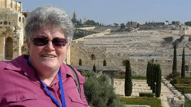 A holiday picture of the victim, Davinia Graham, shows her wearing sunglasses and smiling at the camera, in front of a number of stone buildings stretching into the background.