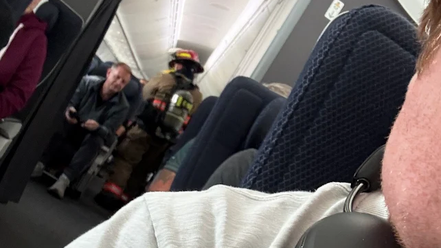 A firefighter in the aisle of a plane at Harry Reid International Airport in Las Vegas.