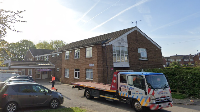 Exterior shot of Hazel Garth Care Home, a two-storey brick building