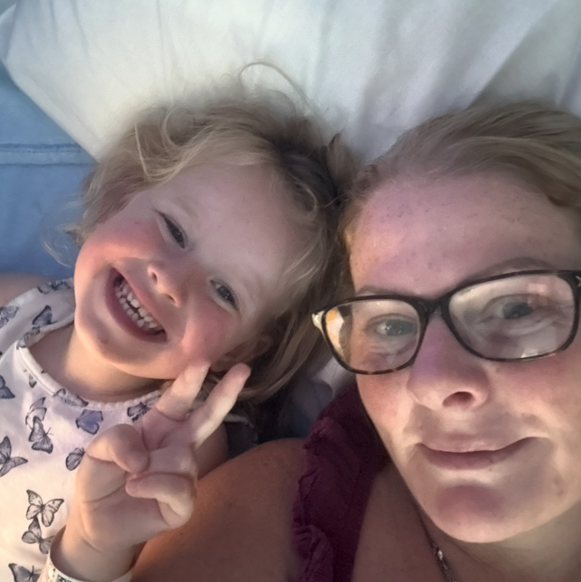 Selfie of Eliyah and Kelly lying on a bed