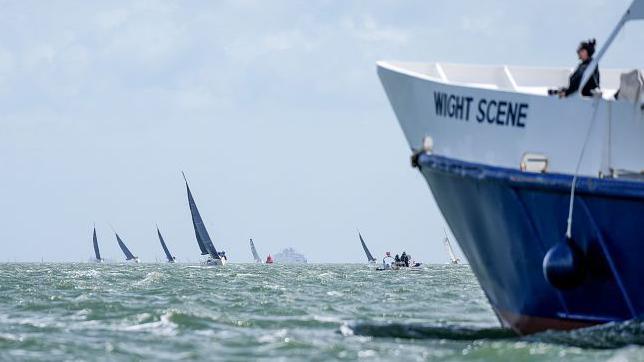 yachts at sea with one vessel in the foreground with the  words wight scene on its side