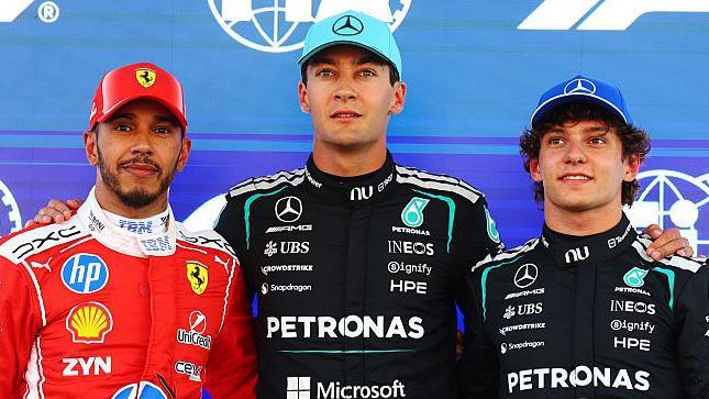 Lewis Hamilton, George Russell and Kimi Antonelli pose for photographs after qualifying for the Barcelona-Catalunya Grand Prix