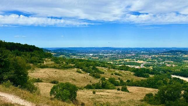 Rolling hills with a blue sky and thin clouds