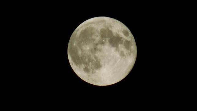 A large moon against a black background