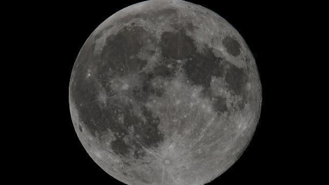 A large grey moon against a black background