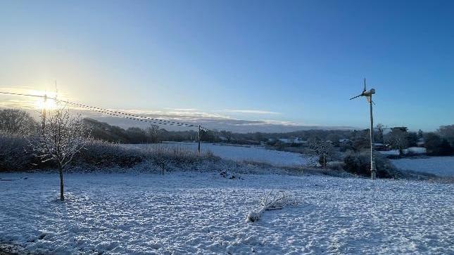 A picturesque field covered with a light dusting of snow. 