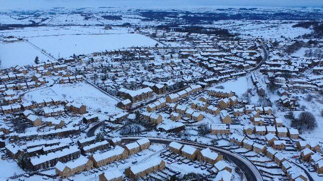 An aerial view of snow on houses in rural Bradford 