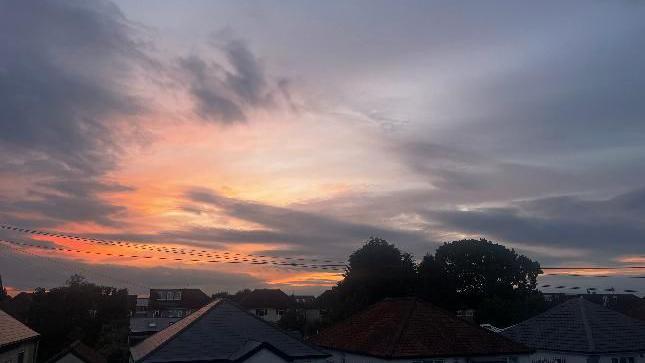 Orange sky over houses