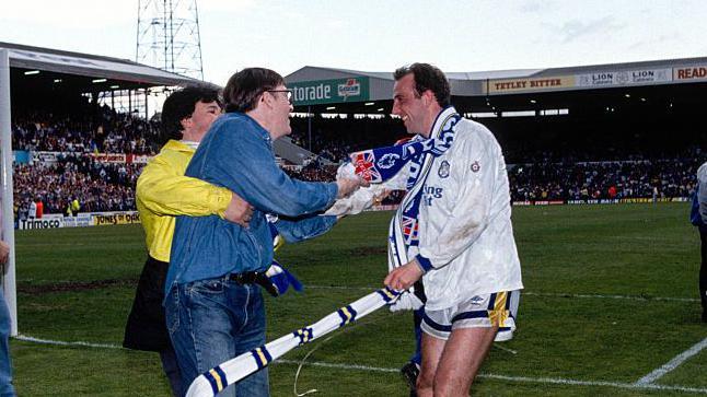 Gary McAllister of Leeds United congratulated by a fan