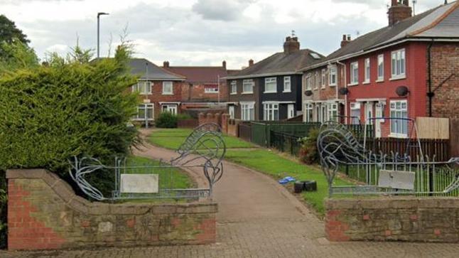 A path leading between a row of houses