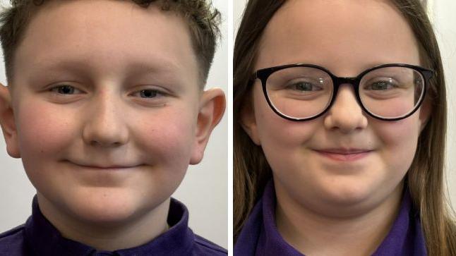 A boy with curly brown hair and a girl with long brown hair and black-rimmed glasses. Both are wearing purple tops.