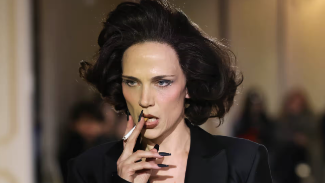 A model smokes as she walks the runway at the Christian Cowan fashion show at New York fashion week in February.