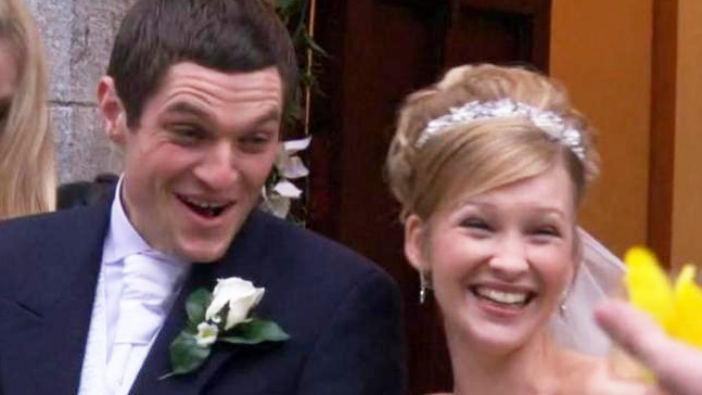 A scene from series one of Gavin & Stacey: Gavin and Stacey in their wedding attire smiling outside the church