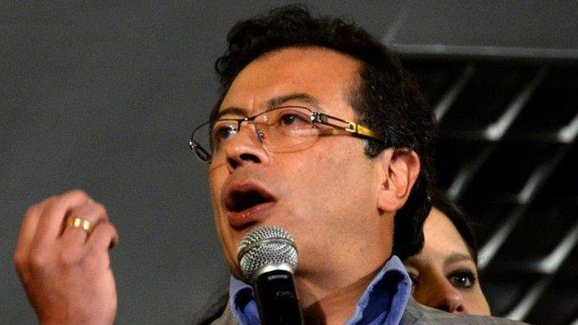 This file picture shows former Bogota Mayor Gustavo Petro speaking to supporters from the City Hall balcony in downtown Bogota after Colombian President Juan Manuel Santos announced his dismissal on 19 March, 2014