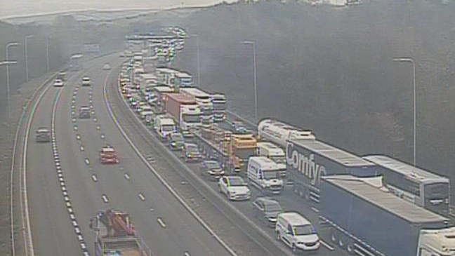 Long tailbacks on the M62, with hills in background.