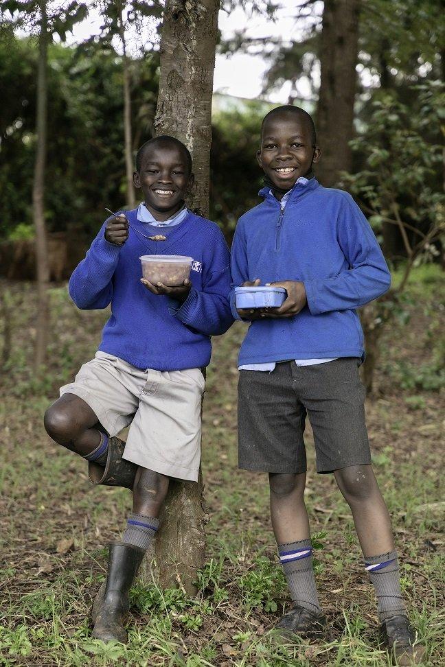 two-boys-holding-containers-with-food.