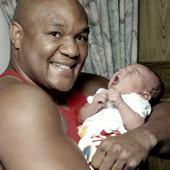 Foreman holding his baby son George III