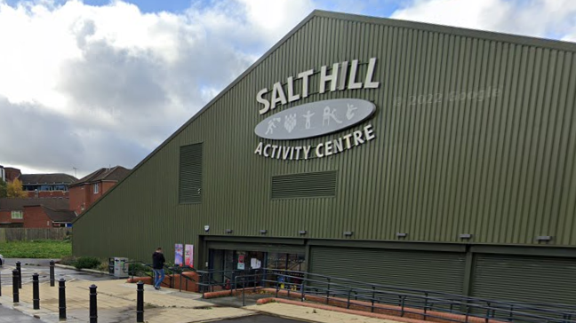 Salt Hill Activity Centre is a triangular, dark green building with a few steps leading down to the main entrance.