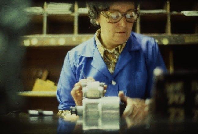  Cashier counting bus takings at unidentified garage, by Ian Bell, about 1980