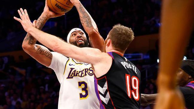 Anthony Davis goes up for a shot against Jakob Poeltl of the Toronto Raptors