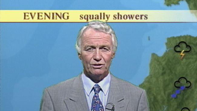 Craig Rich seen presenting the weather forecast. He is seen wearing a grey suit with a white shirt and blue patterned tie. In the image he has short white wavy hair and is clean shaven.