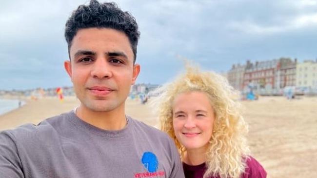 A selfie of Akhtar Mohammad and Heather on the beach at Weymouth