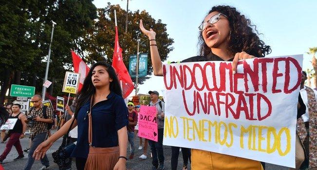 Young immigrants, activists and supporters of the DACA program march through downtown Los Angeles, California.