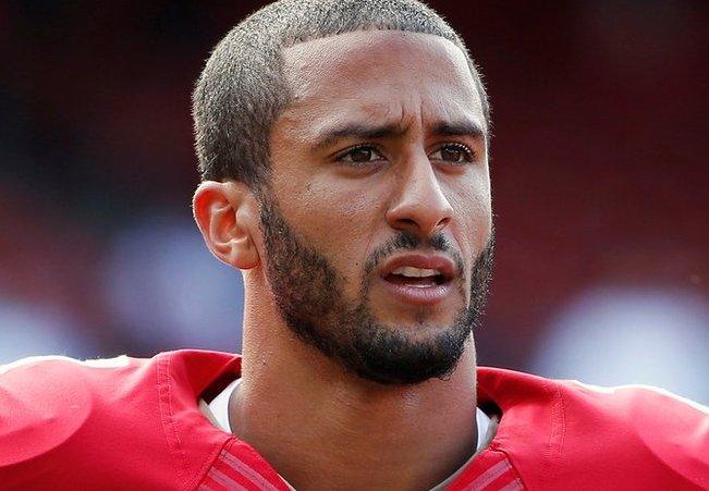 San Francisco 49ers quarterback Colin Kaepernick stands on the field before their NFL pre-season football game against the Denver Broncos