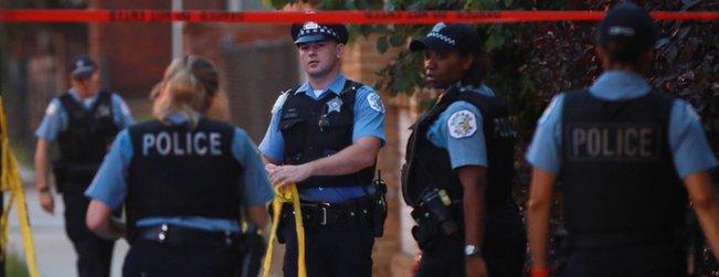 Police officers reuse crime scene tape on July 28, 2016, in Chicago.