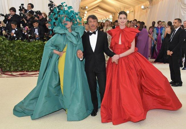 Actress Frances McDormand (L), Valentino designer Pierpaolo Piccioli (C) and actress Anne Hathaway (R) appear together on the red carpet.