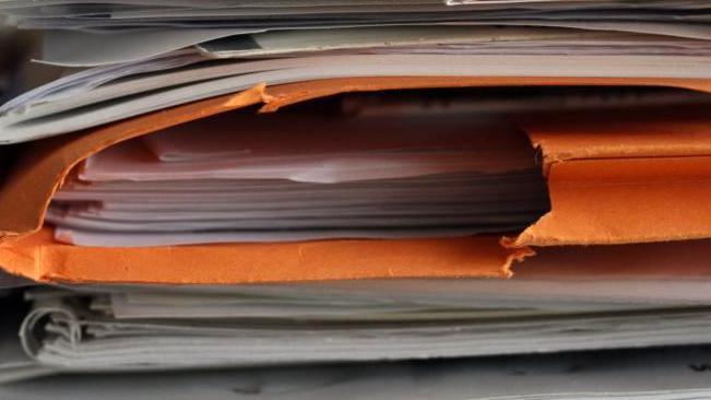 A stack of folders with papers inside