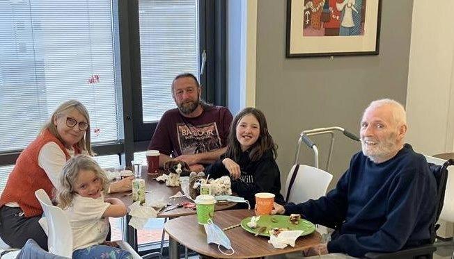 Jim with his family visiting him in hospital