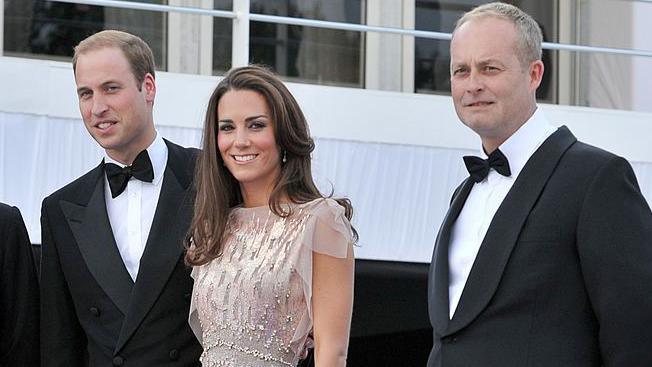 The financier and Prince William are wearing dinner jackets and Catherine, Princess of Wales a sleeveless dress.