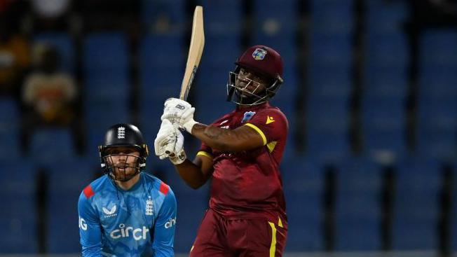 Evin Lewis hits a boundary against England