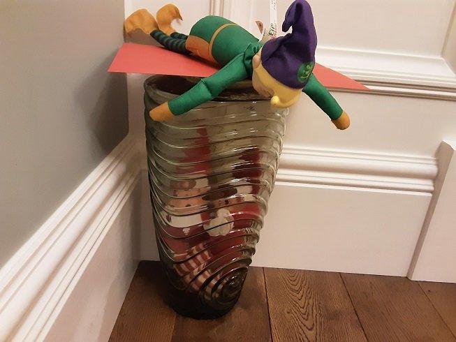 two elves in a vase, one on top