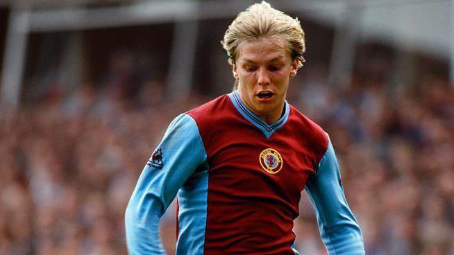 Gary Shaw pictured during a football match - he is a man with blonde hair and wearing a claret and blue Aston Villa shirt.