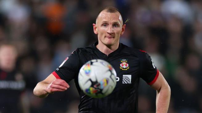 Will Boyle stares at the ball as he chases after it during a game