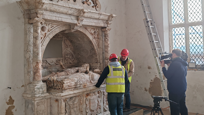 Conservationists are filmed examining the Grey monument