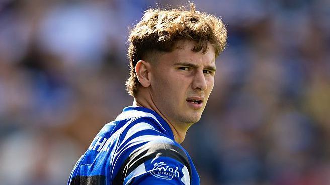 Ciaran Donoghue in the blue, black and white shirt of Bath