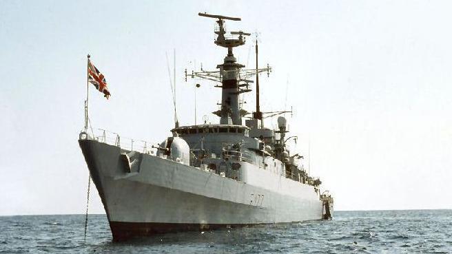 HMS Ambuscade sailing on water with flag raised