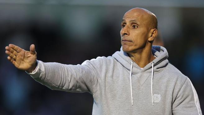 Barrow manager Dino Maamria directs proceedings from the dugout