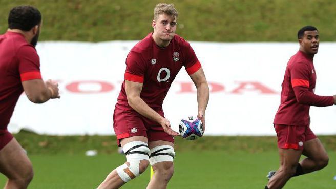 Alex Coles throws a ball in England training