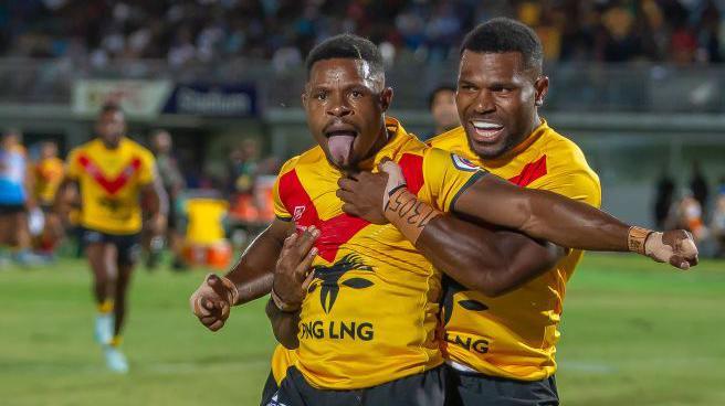 Judah Rimbu celebrates a try with a team-mate