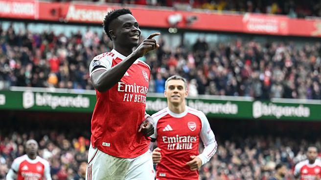 Bukayo Saka celebrates after scoring for Arsenal