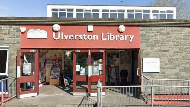 Red library building with sign saying 'Ulverston Library'