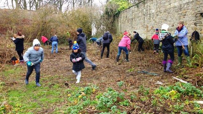 A group of people working in a walled garden