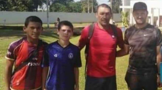 Diego Leon (left) with Hernan Acuna (centre right) after he joined Cerro Porteno aged 12