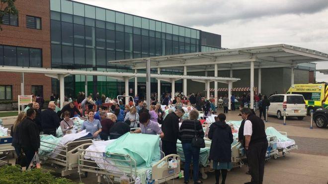 Patients outside the Stoke hospital after being evacuated.