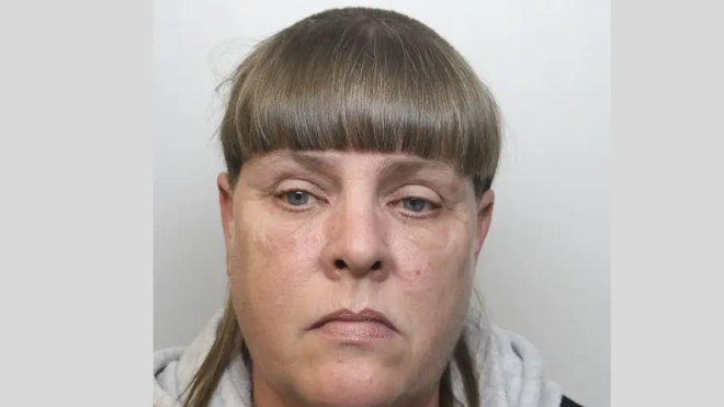 Photo of Jane Hill - she is wearing a grey hoodie top and not smiling. 