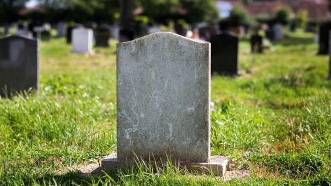 A headstone in a graveyard